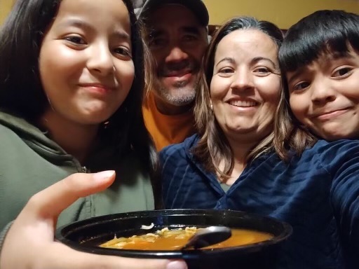 A family smiling together during a shared meal