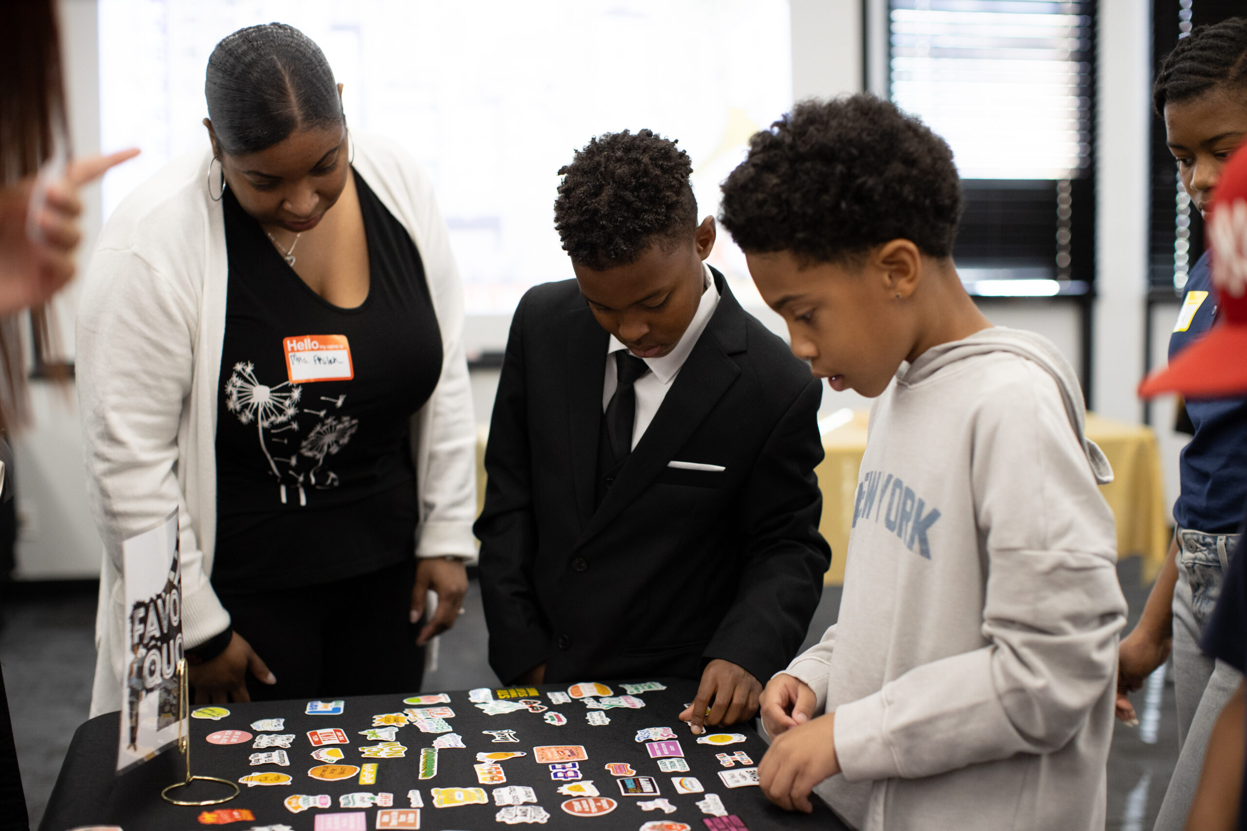 Students and an adult explore an activity table at a Let’s Rise Above conference